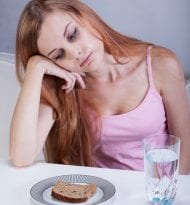 Girl on diet can't eat breakfast, vertical