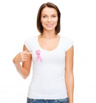healthcare, medicine and breast cancer concept - woman in blank t-shirt with pink cancer ribbon